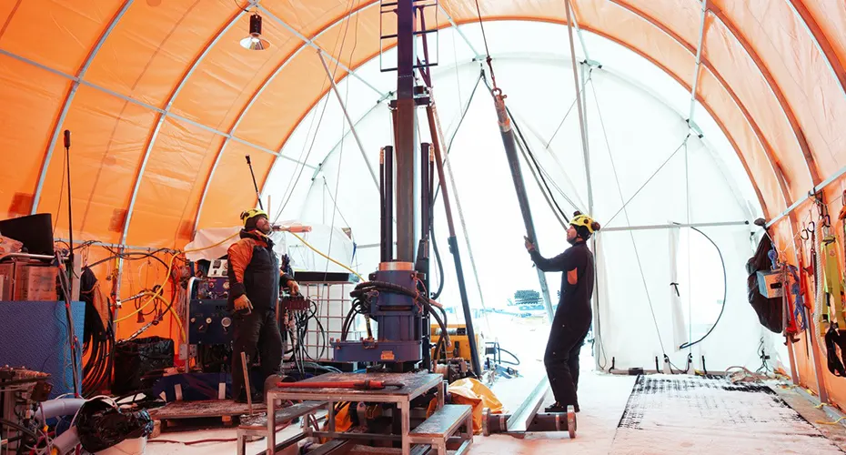 Researchers working beneath a tent